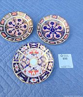 Three Royal Crown Derby plates front view