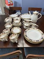Full assortment of Royal Crown Derby "Derby Border" china set displayed on table