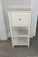 Front view showing overall design with drawer and two shelves