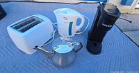 Group shot of Keurig brewer, Oster kettle, toaster, and Strauss teapot