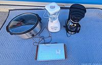 Group shot of coffee maker, slow cooker, blender and warming tray