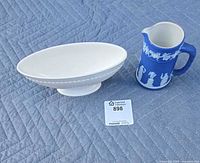 Both Wedgwood items side by side on quilt