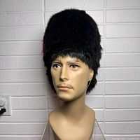 Front view of black faux fur guard hat on mannequin head