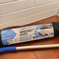 Windshield cover in bag with label and attached snow brush