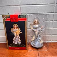 Box front and tree topper in plastic insert displayed on table