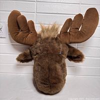 Front view of plush moose head showing antlers, fur and overall size