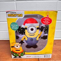 Front of retail box showing Minions Stuart 3.5-ft inflatable Christmas decoration