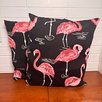Front view of both flamingo pillows upright