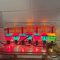 full view of 9 illuminated bubble lights on string