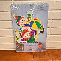 Front of sealed package showing paperboard clown decor