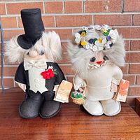 Full view of both bride and groom plush dolls standing together
