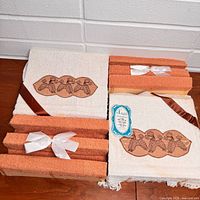 Entire set of white and rust terrycloth towels tied with ribbons