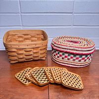 Overall lot showing Longaberger basket, straw basket with lid, and six coasters