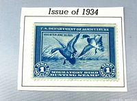 Front view of 1934 $1 Migratory Bird Hunting stamp on album page
