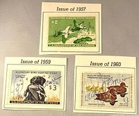Front view of three stamp issues 1957, 1959, 1960 on album cutouts