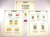 Three Minkus album pages with attached 1969 U.S. commemorative stamps