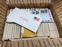 Overview of box filled with envelopes with visible stamps and air-mail borders