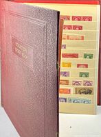 Front cover of maroon collector stock book partially open showing stamp rows