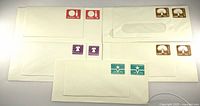 Front view of all six stamped envelopes showing postage designs and sizes