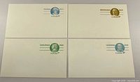 Fronts of four prepaid postcards showing different patriots and denominations