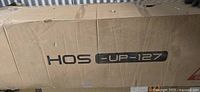 Box labeled HOS UP-127 containing sofa components