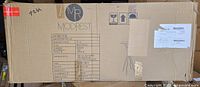 Sealed shipping carton with Modrest logo and table graphic