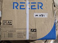 Closed cardboard box labeled Recer containing Merola Triplex Real Black ceramic wall tiles