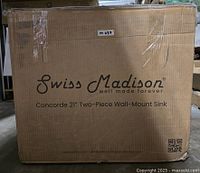 Factory sealed box labeled Swiss Madison Concorde 21" Two-Piece Wall-Mount Sink