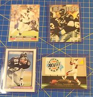 Group shot of all four Deion Sanders trading cards in sleeves