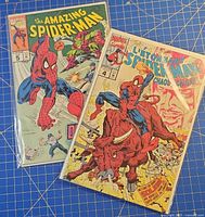 Both bagged Amazing Spider-Man comics No.4 and No.5 on blue grid background