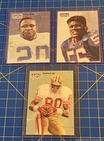 Three Pro Set NFL Legends cards in holders