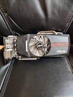 Front view of Asus Radeon HD 6870 graphics card showing fan, shroud and heatpipes