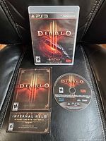Front view of Diablo III PS3 case, disc, manual, bonus flyer