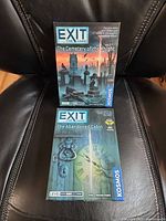 Front view of both boxed Exit: The Game titles, showing artwork and condition