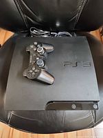 Top view of PS3 Slim with controller on top