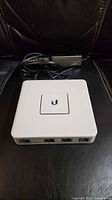 Top view of UniFi Security Gateway with power adapter