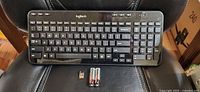 Front view of Logitech K360 keyboard on chair