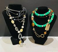 Two necklace groups on display busts showing overall designs