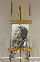 Full view of framed pencil drawing on easel