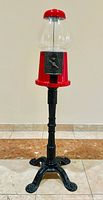 Full view of gumball machine on pedestal stand