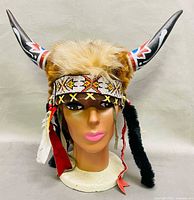Front view showing full headdress, horns, beadwork, feathers