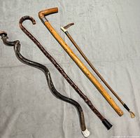 Four canes laid out to show full length and overall styles