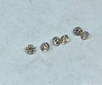 Six loose round diamonds front view