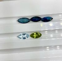 Five marquise gemstones grouped on display tray