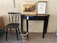 Full lot showing table, chair, art, plaque, urn