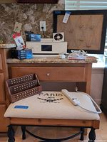 Full lot view showing printer, cartridges, power strips, bulletin board, bench, and letter caddy