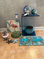 Group shot showing all items including table, planter, canvases, glass orbs, vases, dishes and figurines