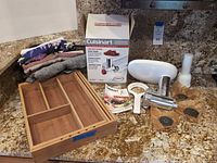 All items together: Cuisinart attachment box, grinder parts, drawer organizer, aprons