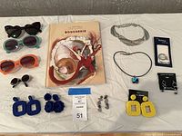 Whole lot overview showing book, sunglasses, jewelry pieces