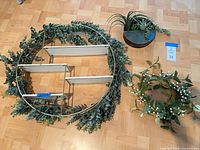Overall view of circular wall shelf, planter and wreath